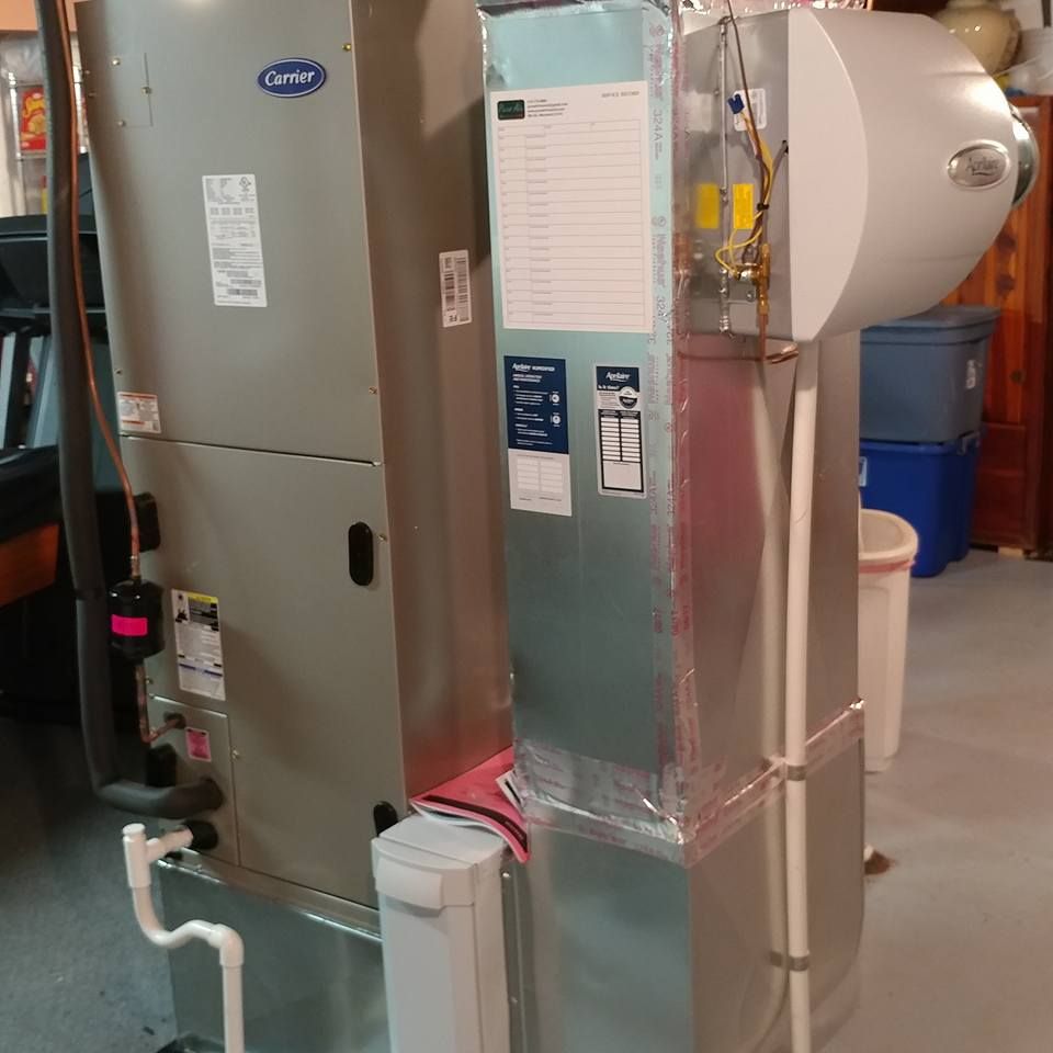 A carrier air conditioner is sitting in a basement