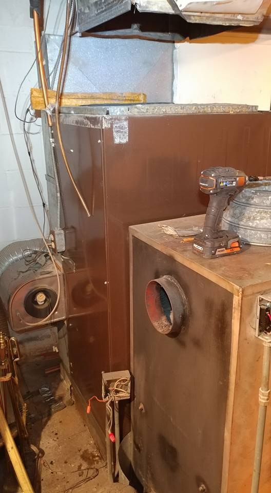 A drill is sitting on top of a wooden box in a room.