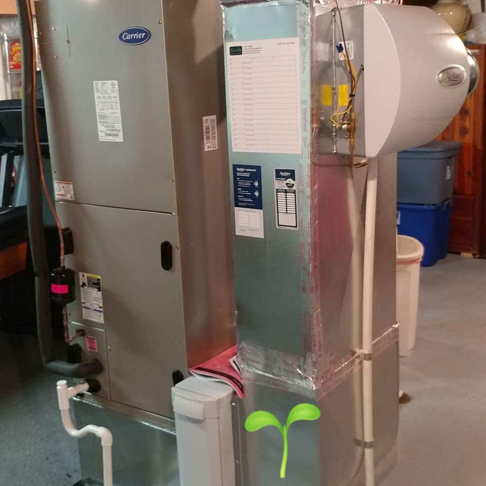 A carrier air conditioner is sitting next to a humidifier