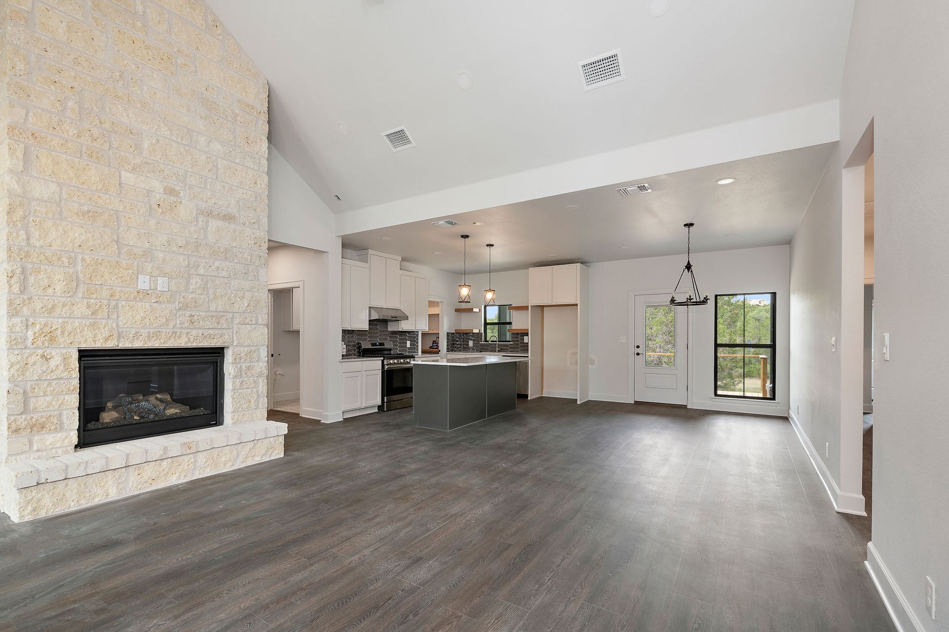 There is a fireplace in the middle of the living room.