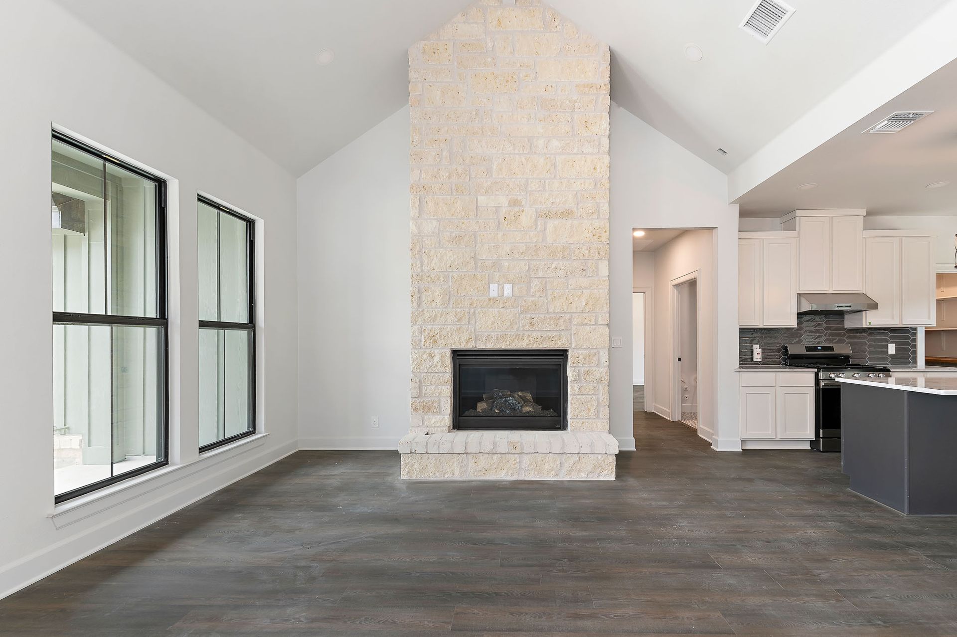 There is a fireplace in the middle of the living room.