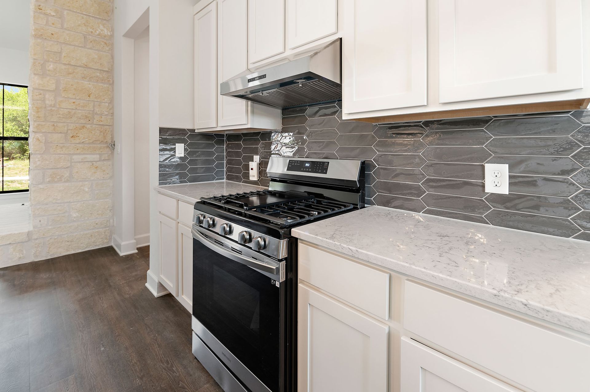 A kitchen with stainless steel appliances and white cabinets.