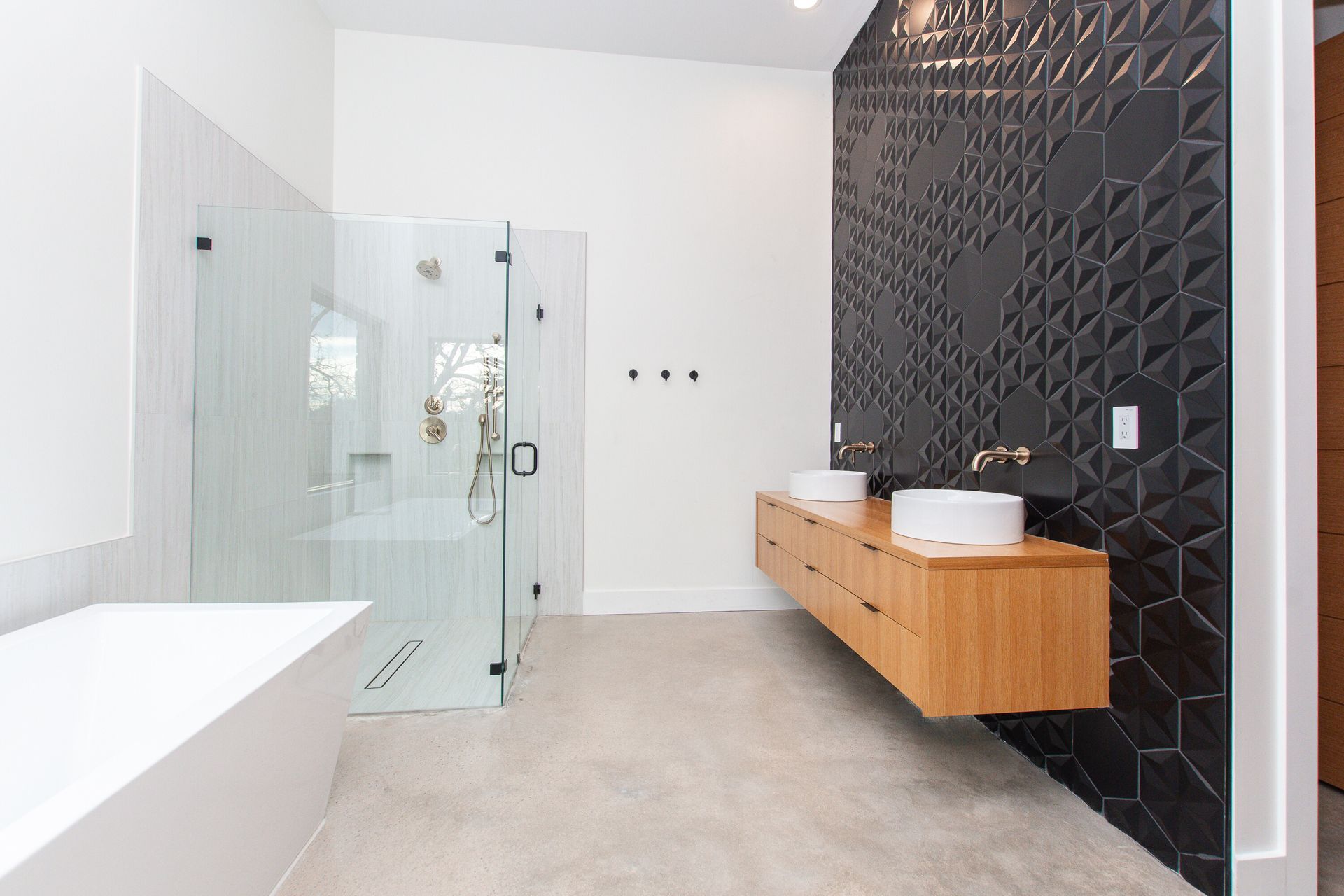 A bathroom with two sinks and a walk in shower.