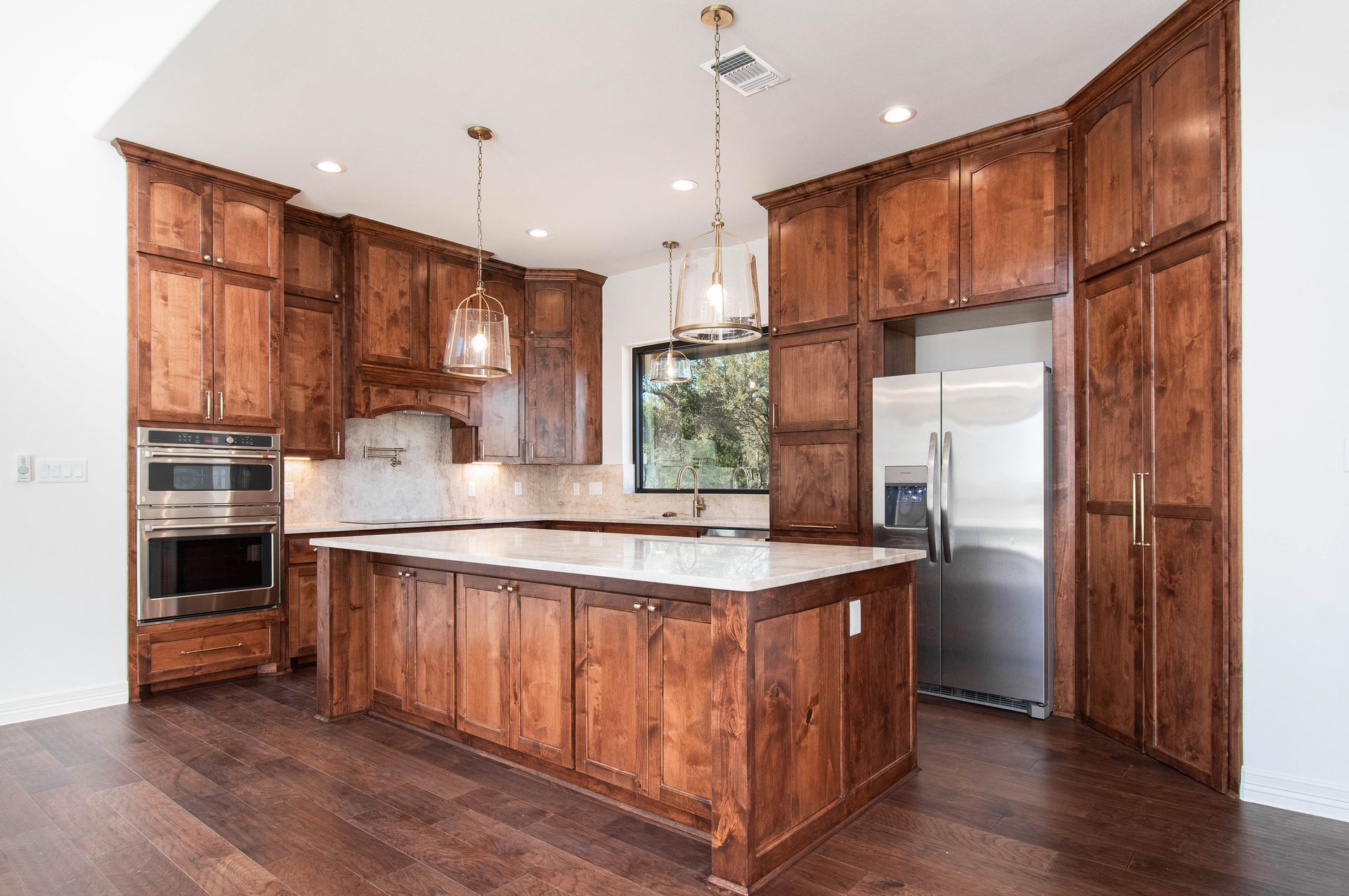 A kitchen with wooden cabinets and stainless steel appliances.