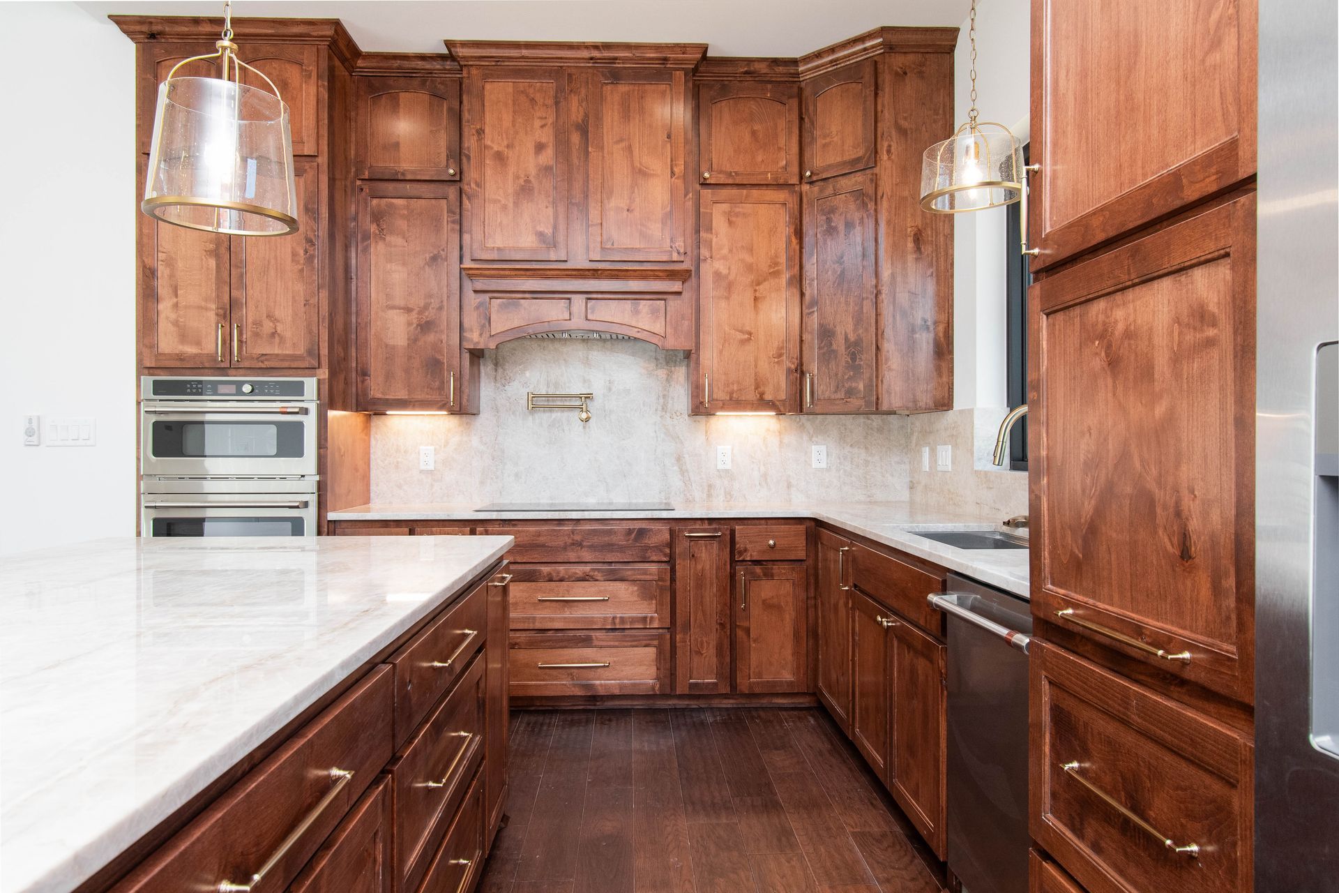 A kitchen with wooden cabinets and stainless steel appliances.