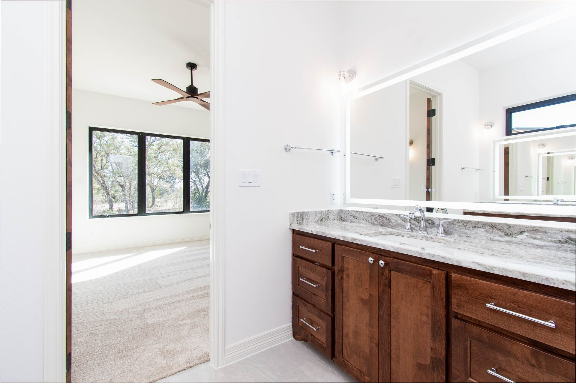 A bathroom with two sinks and a large mirror.
