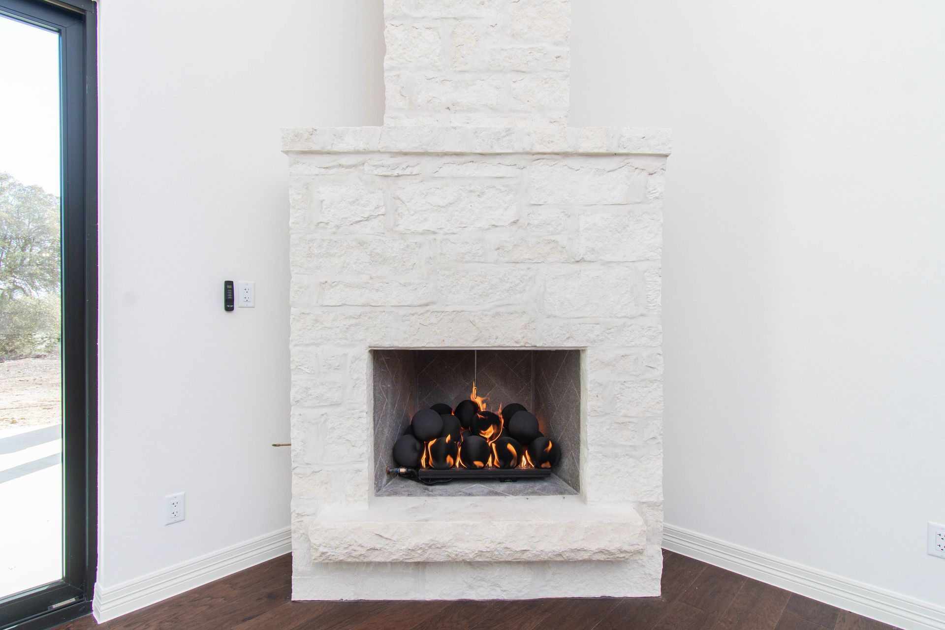 There is a fireplace in the corner of the room.