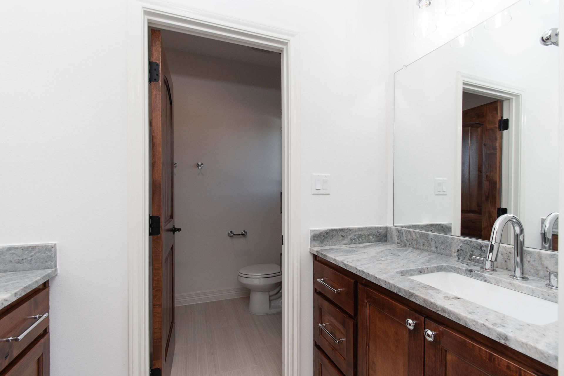 A bathroom with a sink , toilet and mirror.