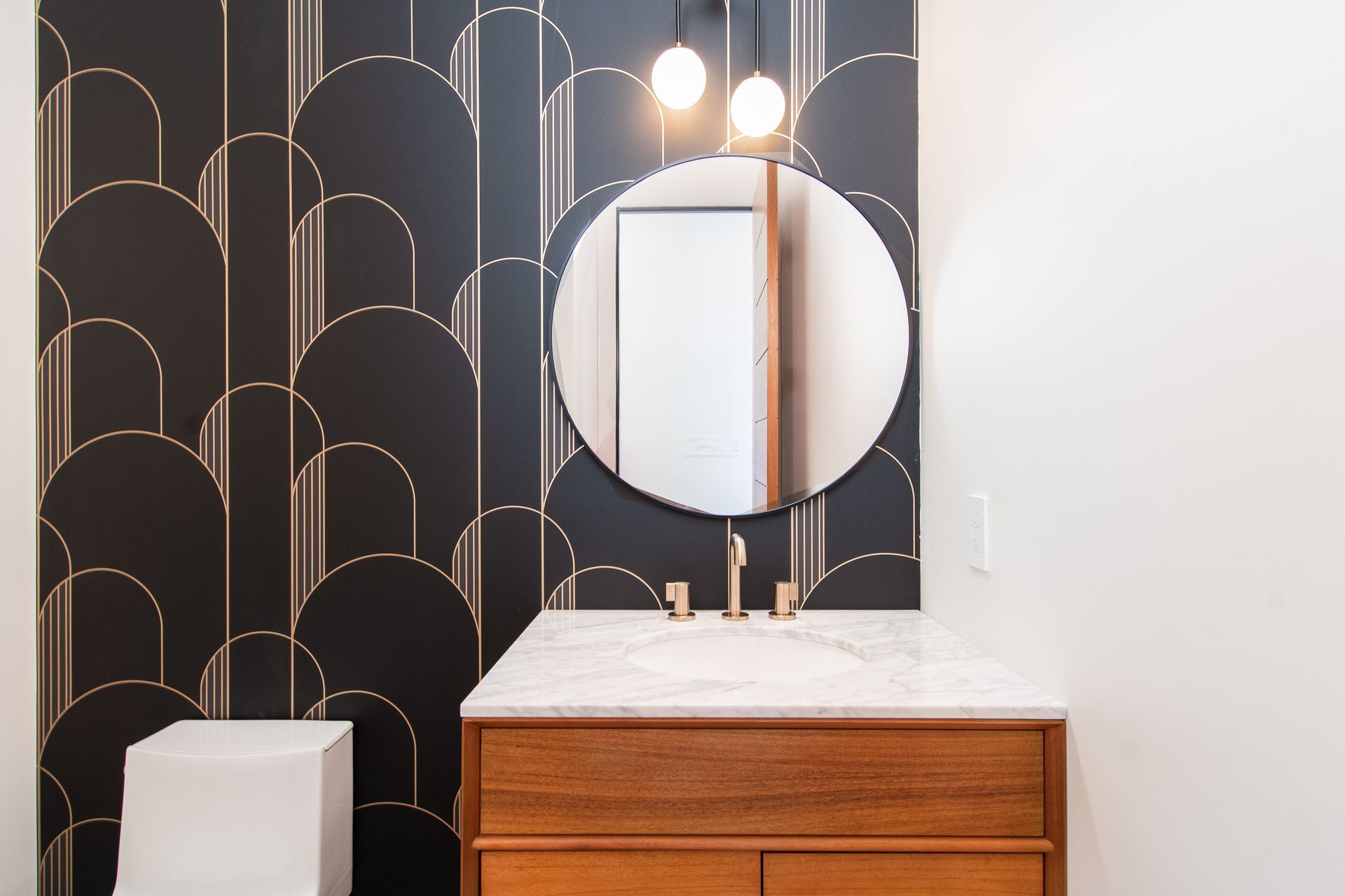 A bathroom with a sink , mirror and toilet.