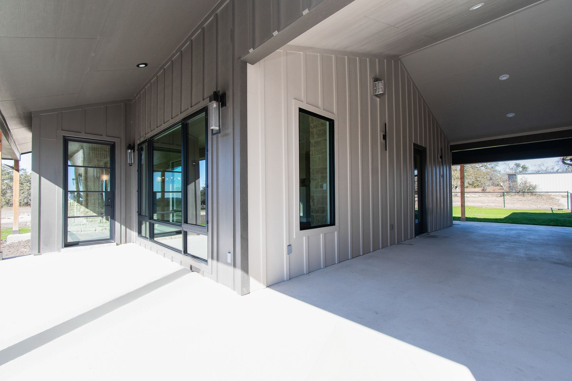 A large house with a covered porch and a garage.