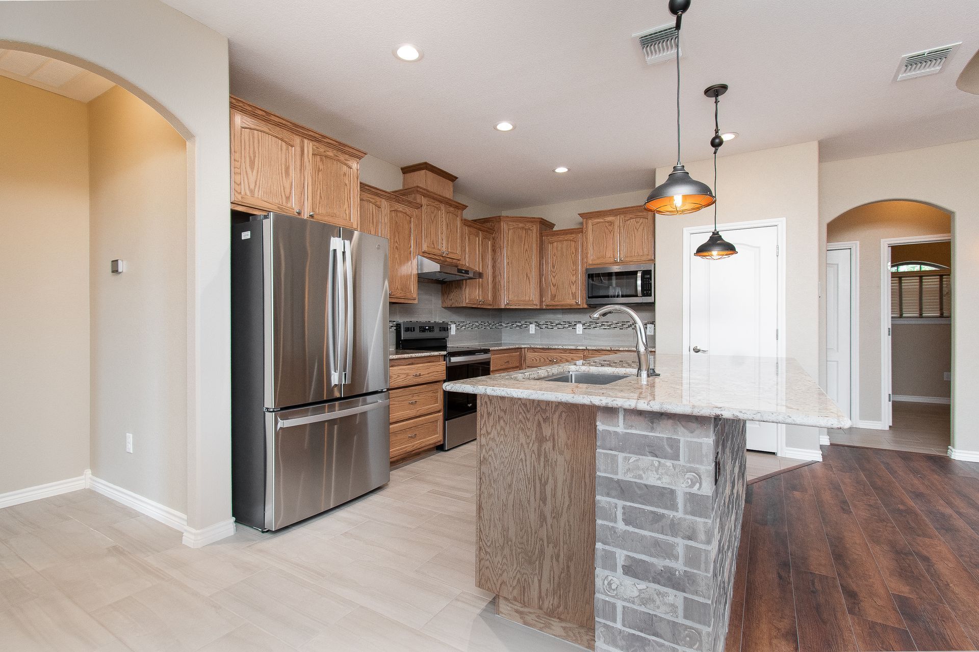 A kitchen with stainless steel appliances and wooden cabinets