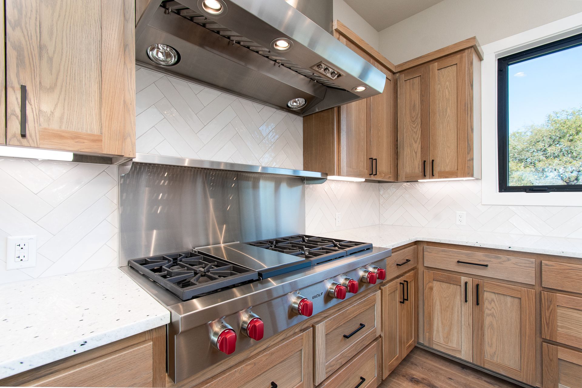 A kitchen with stainless steel appliances and wooden cabinets.