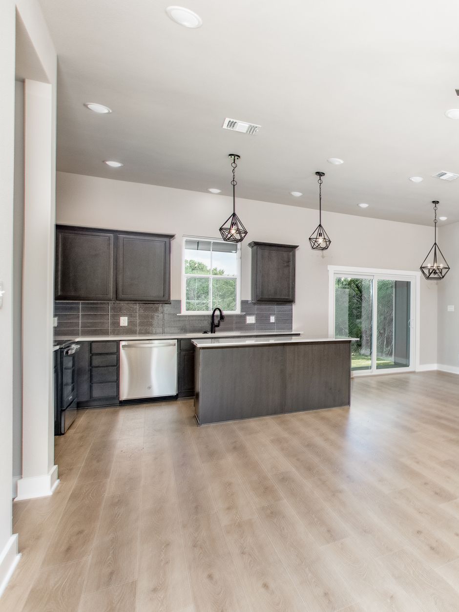 A kitchen with a large island and stainless steel appliances.