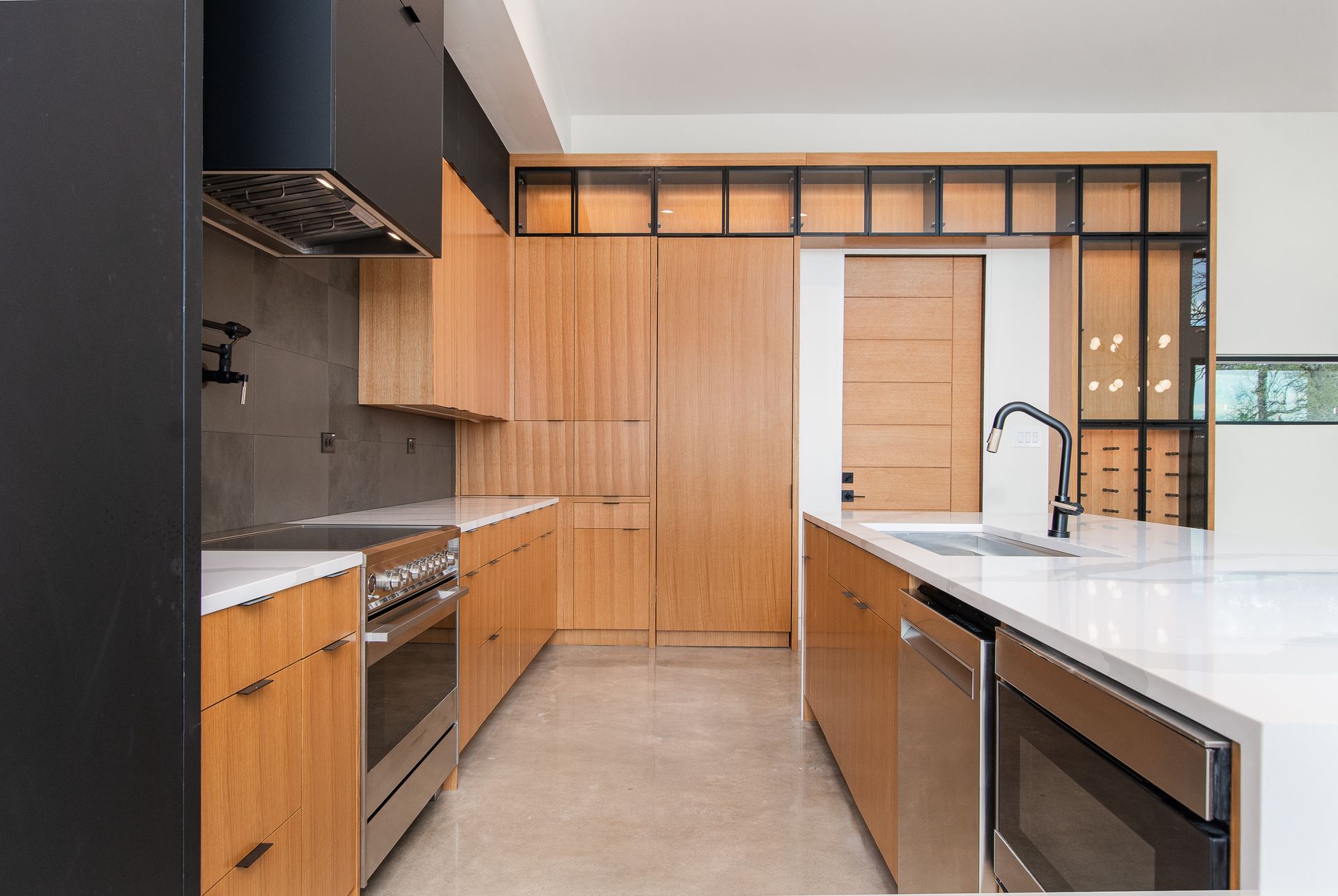 A kitchen with stainless steel appliances and wooden cabinets.