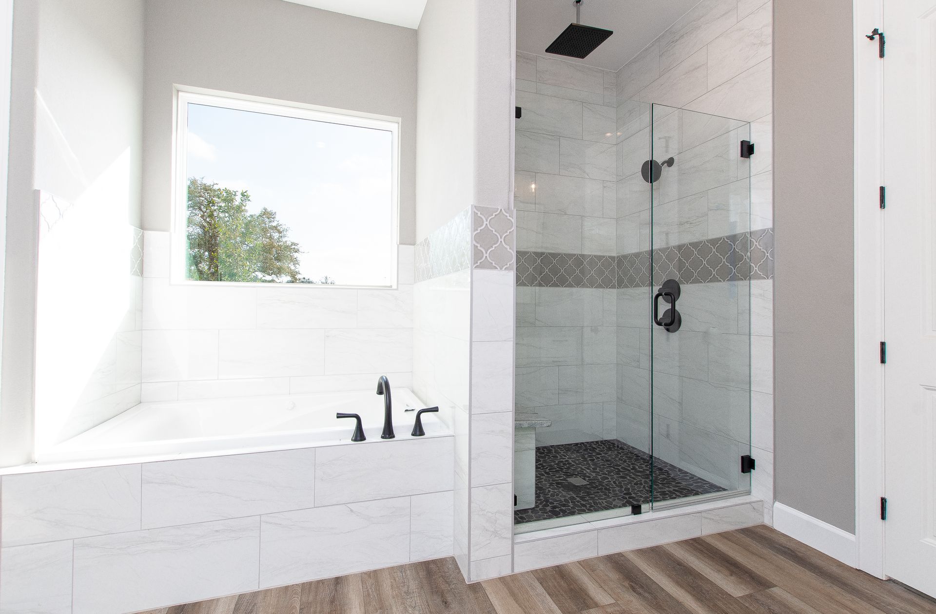 A bathroom with a walk in shower and a bathtub.