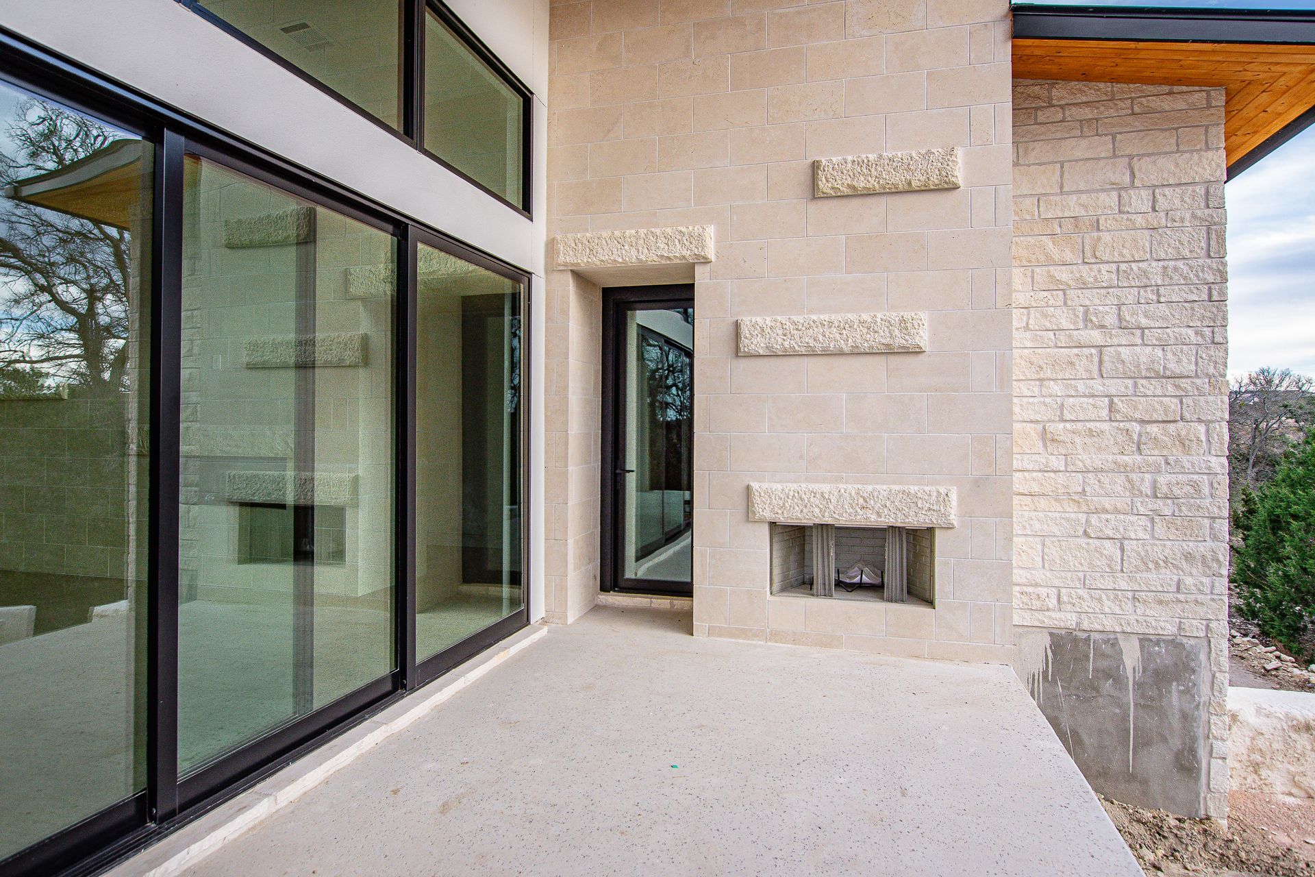 A large house with a lot of windows and a fireplace.
