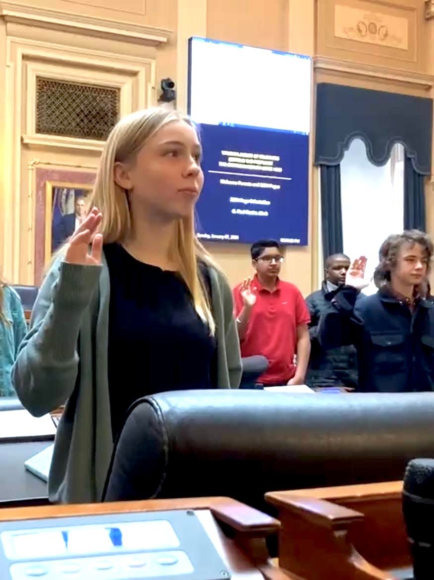 An 8th grade girl gets sworn in to the House of Delegates Page Program