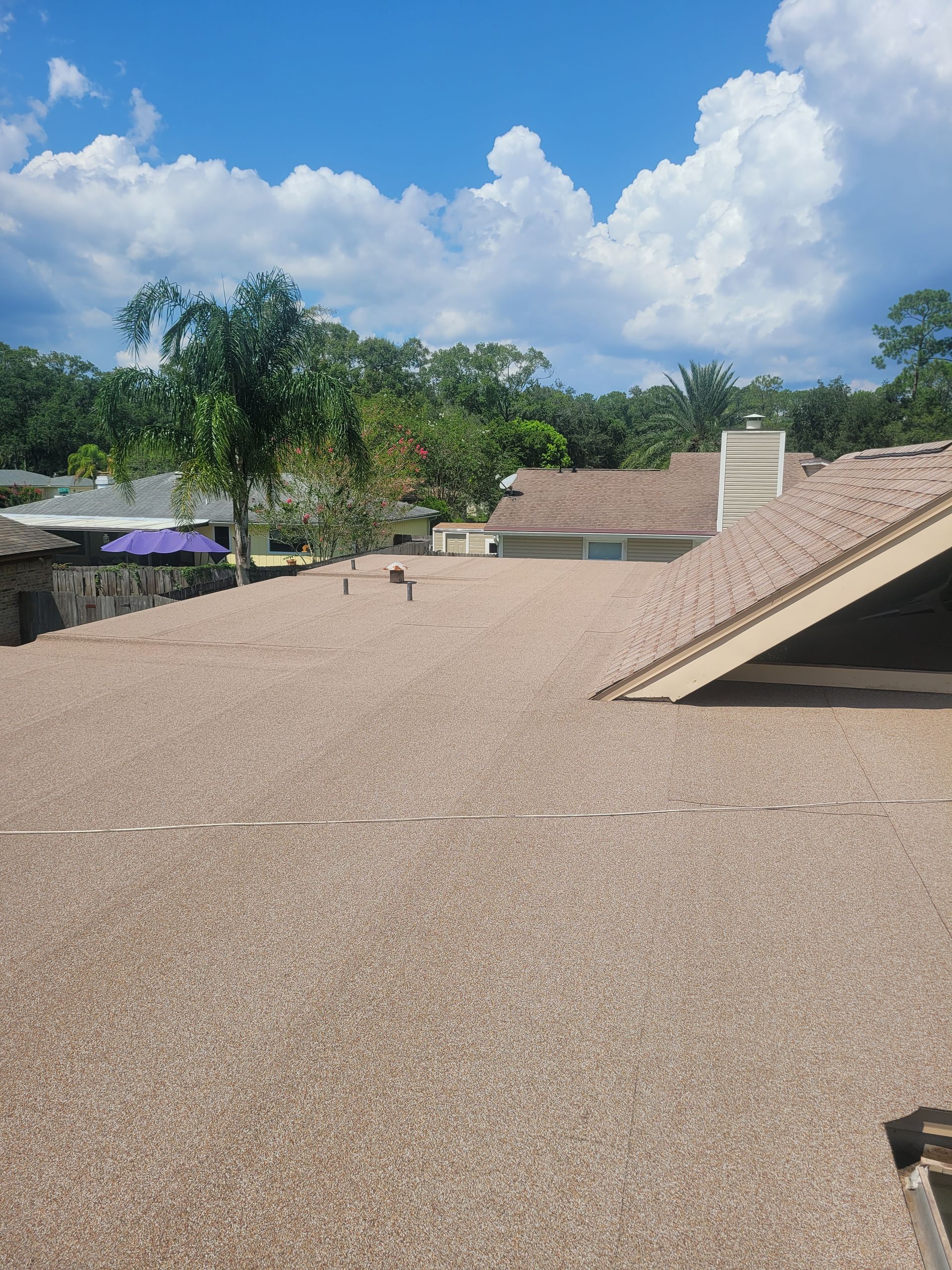A large white house is being built in the middle of a forest.