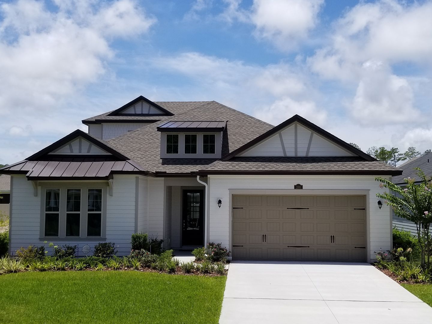 A large white house with a garage and a driveway