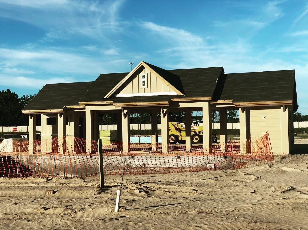 A house is being built in the middle of a dirt field.