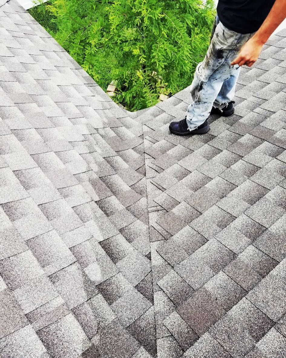 A man is standing on top of a roof.