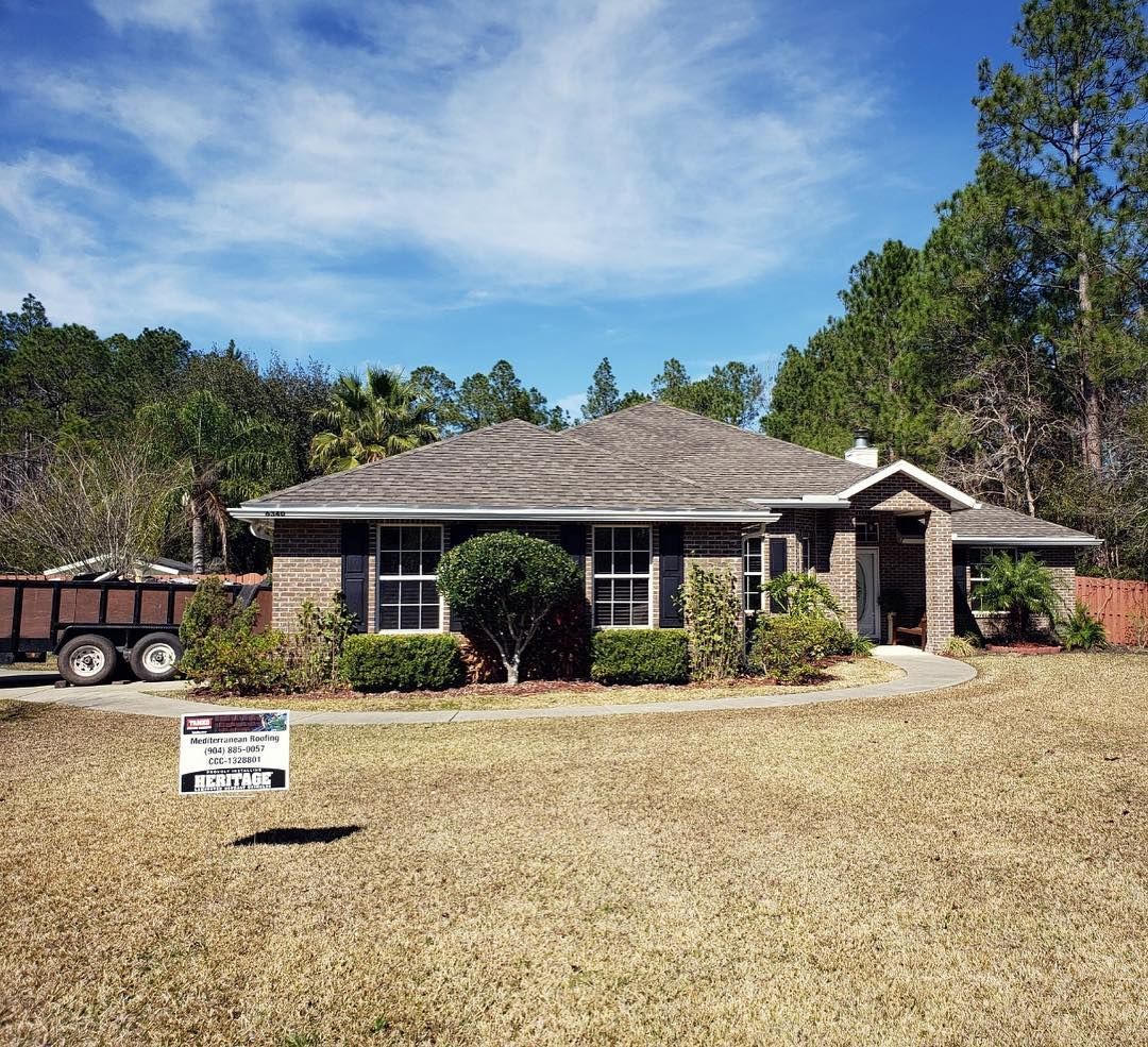 A house with a for sale sign in front of it