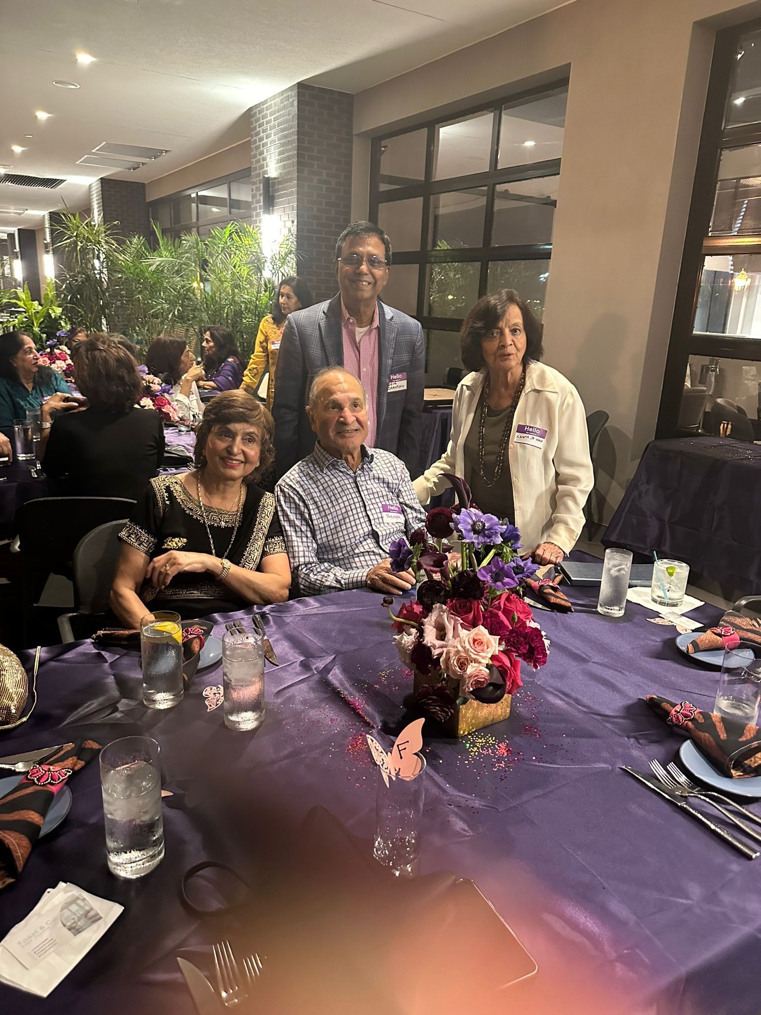 A group of people are posing for a picture at a table.