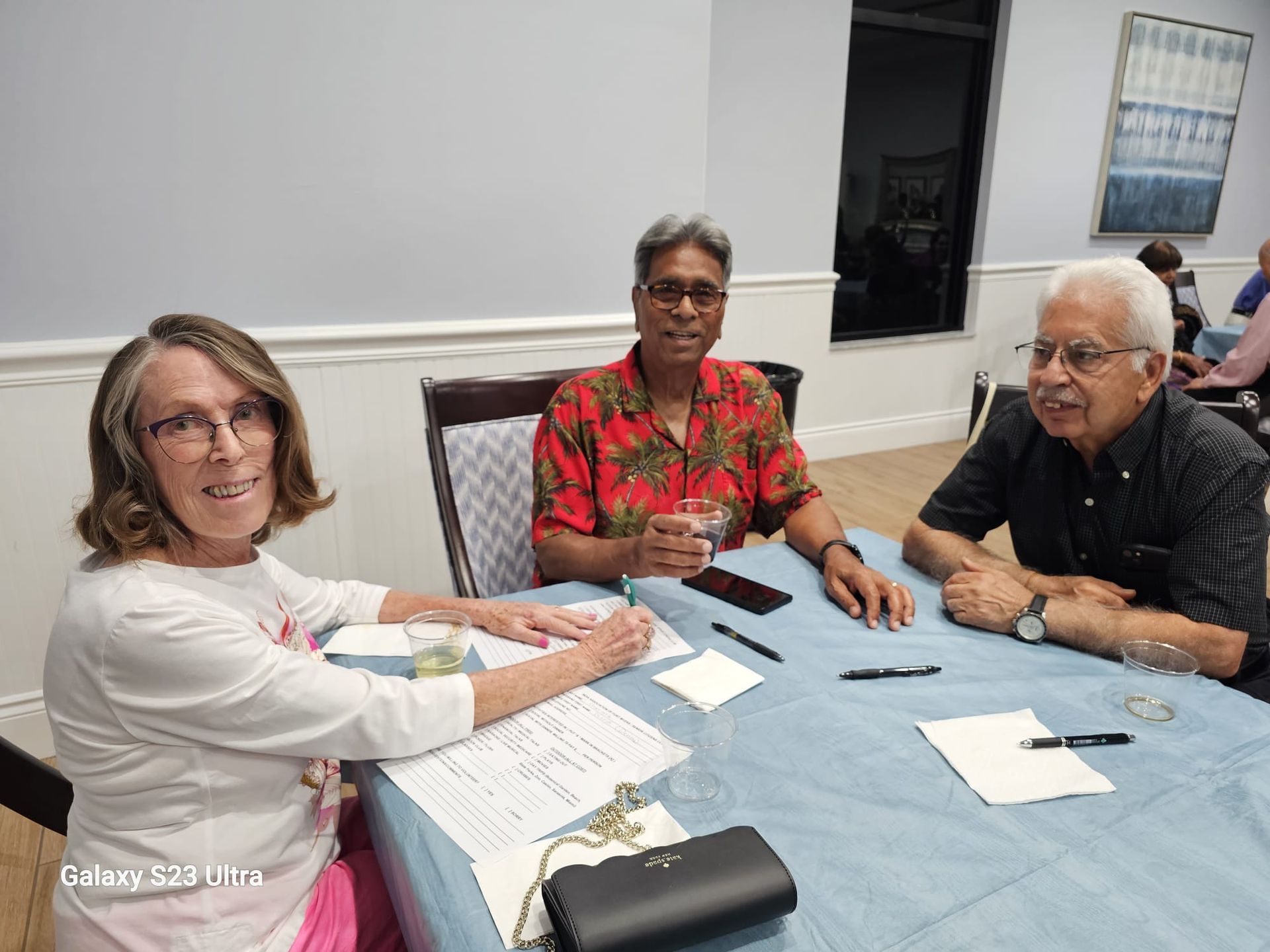 A group of people are sitting at a table in a room.