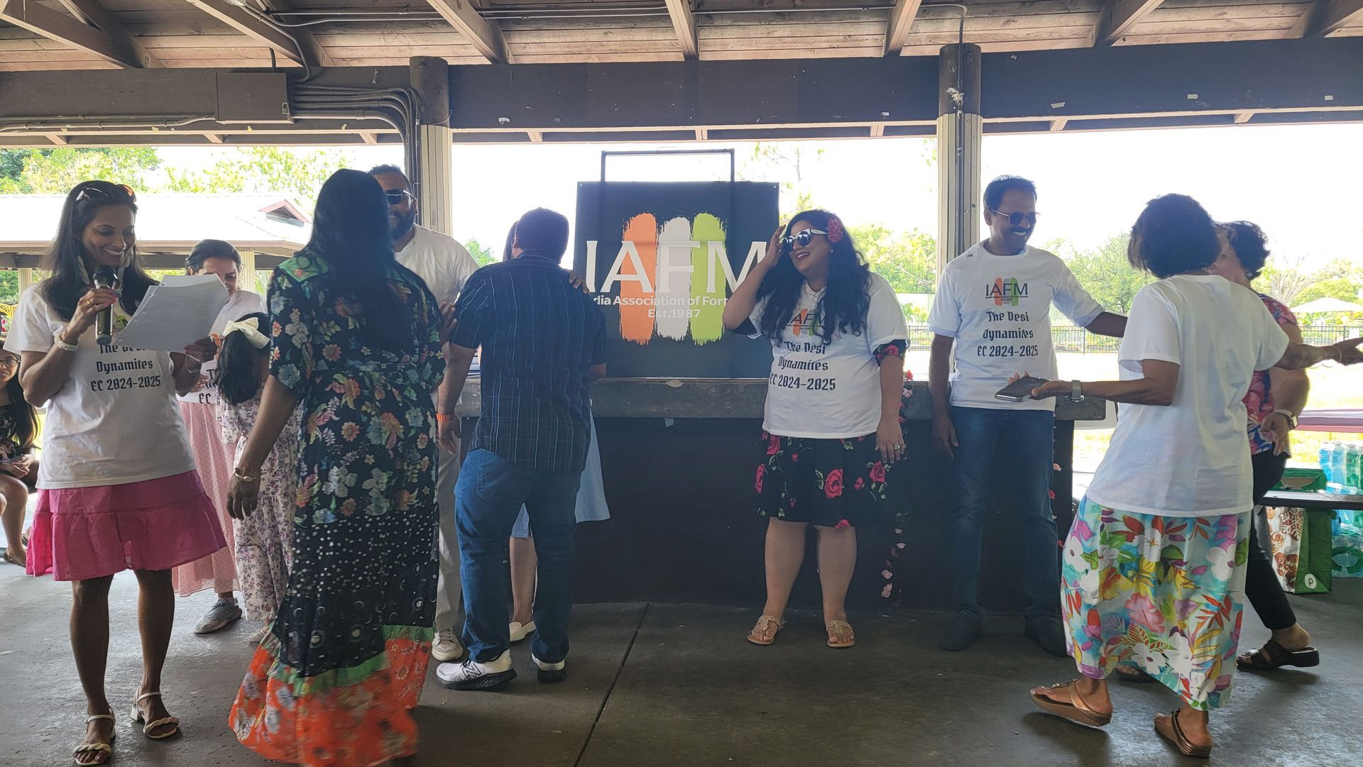 People at a party; some are wearing white t-shirts. 