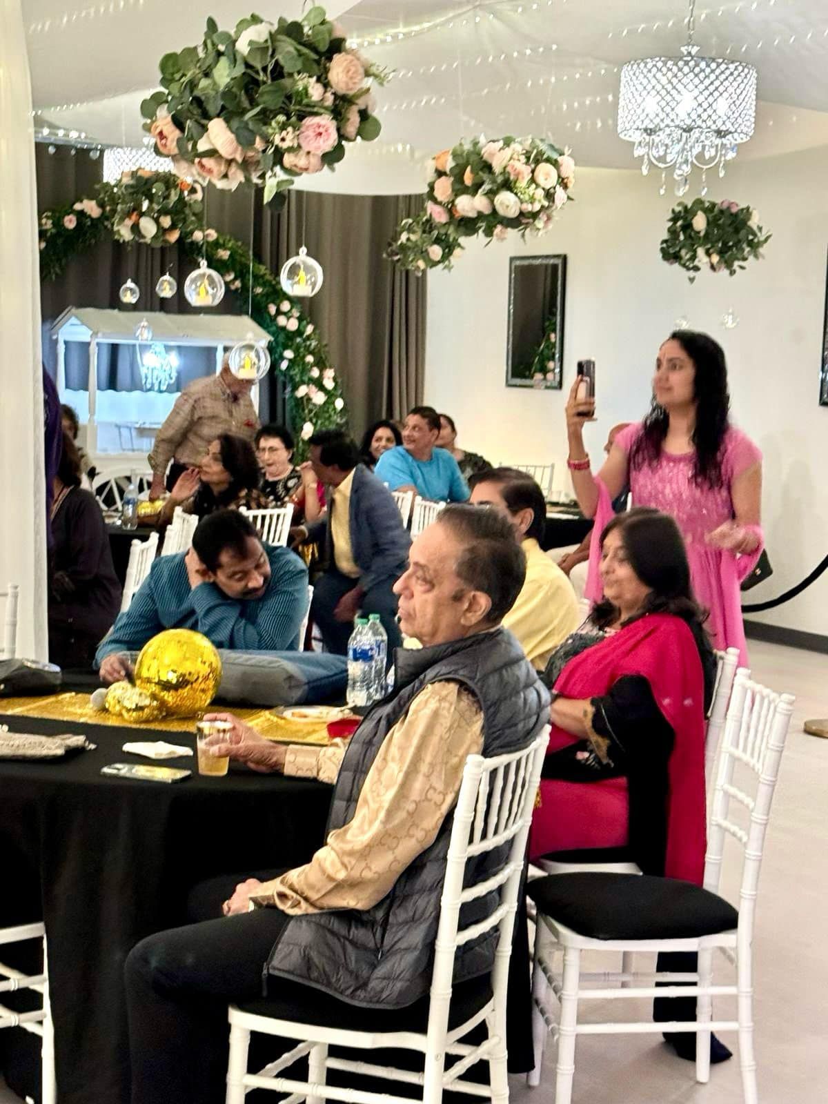 A group of people are sitting at tables in a room.