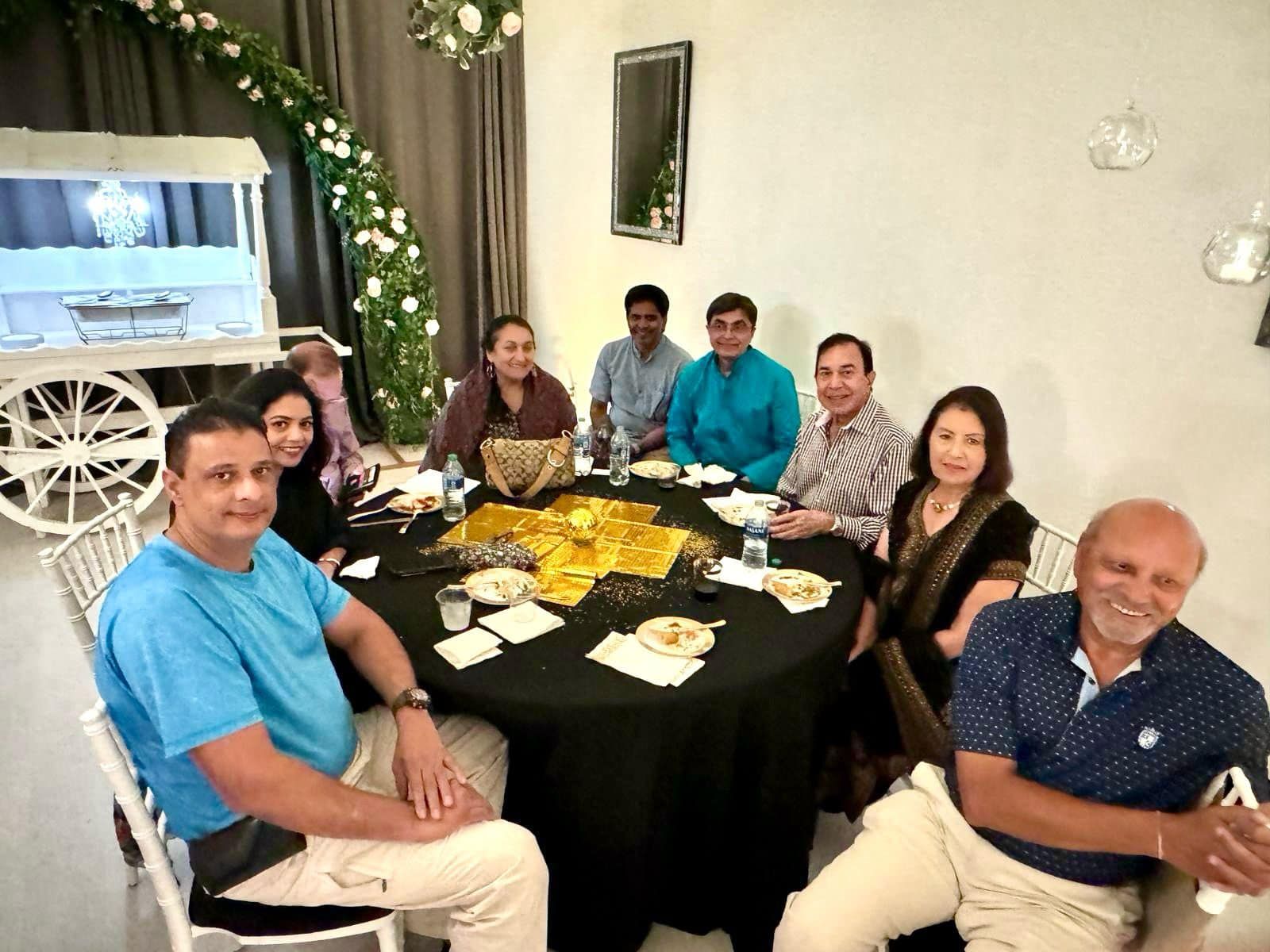 A group of people are sitting around a table in a room.