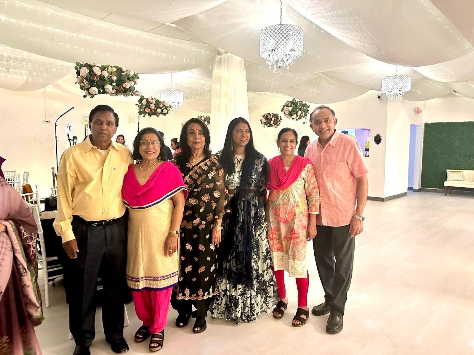 A group of people are posing for a picture in a room.
