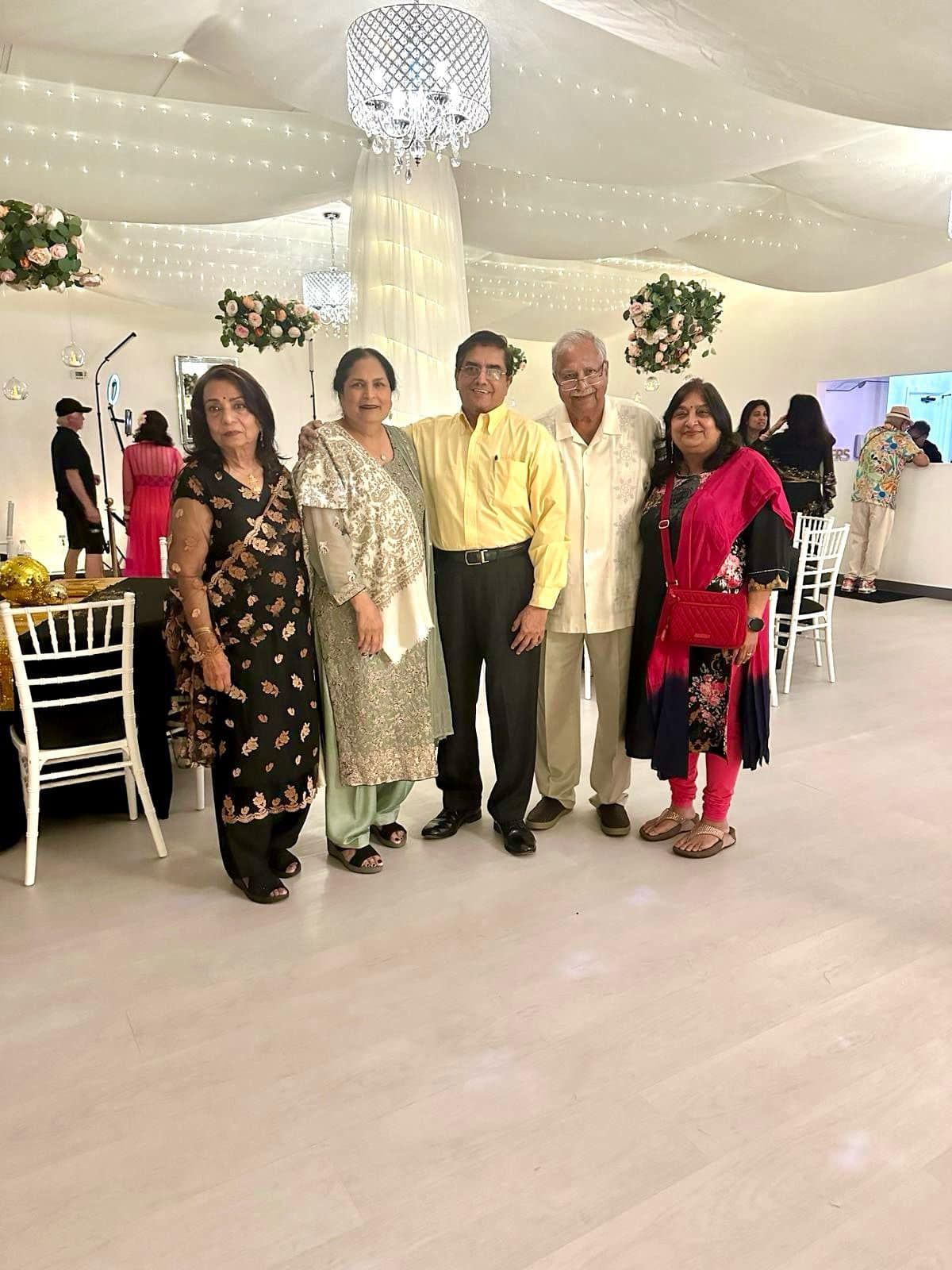 A group of people are posing for a picture in a room.