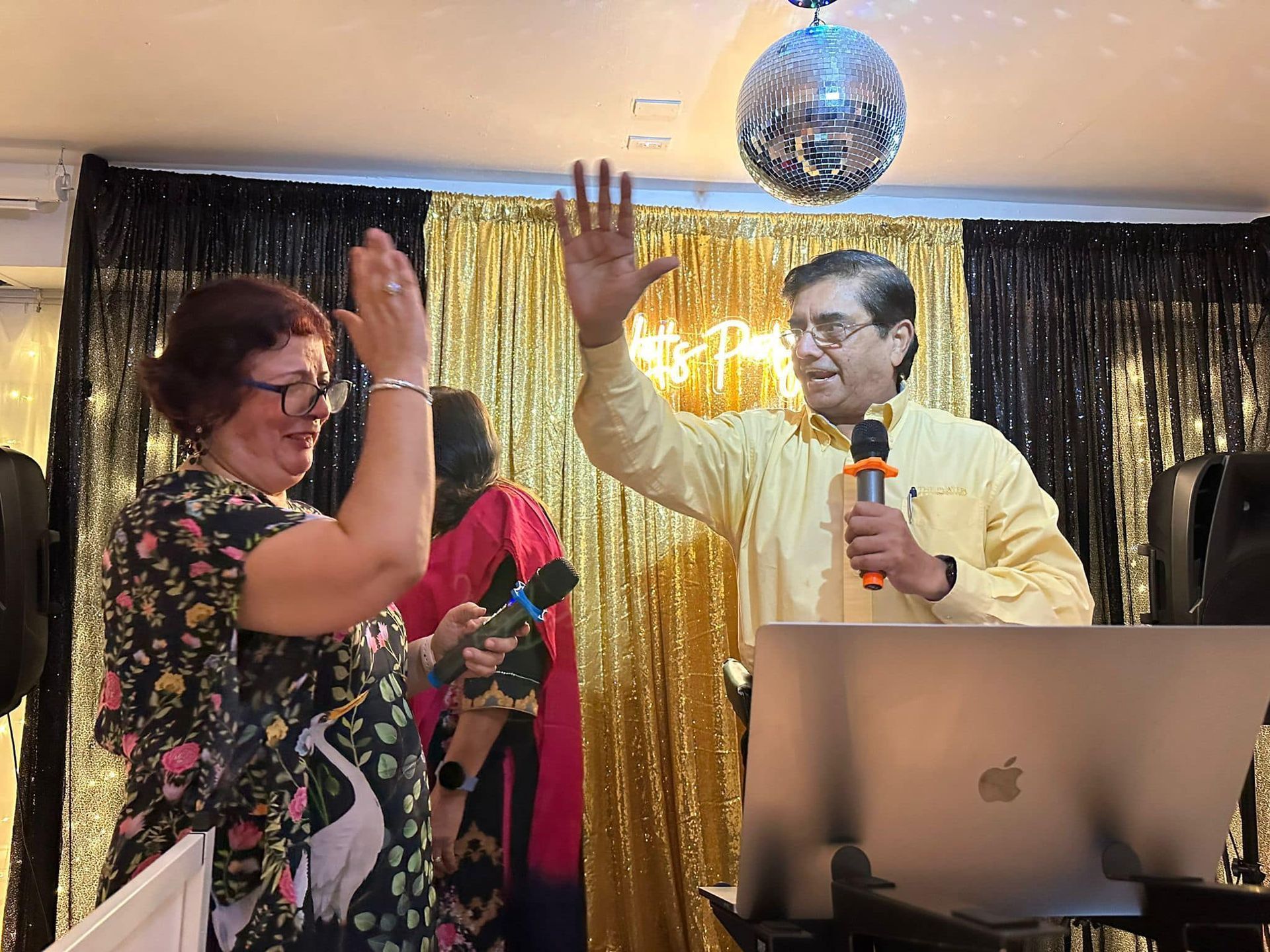 A man is holding a microphone and a woman is holding a microphone.