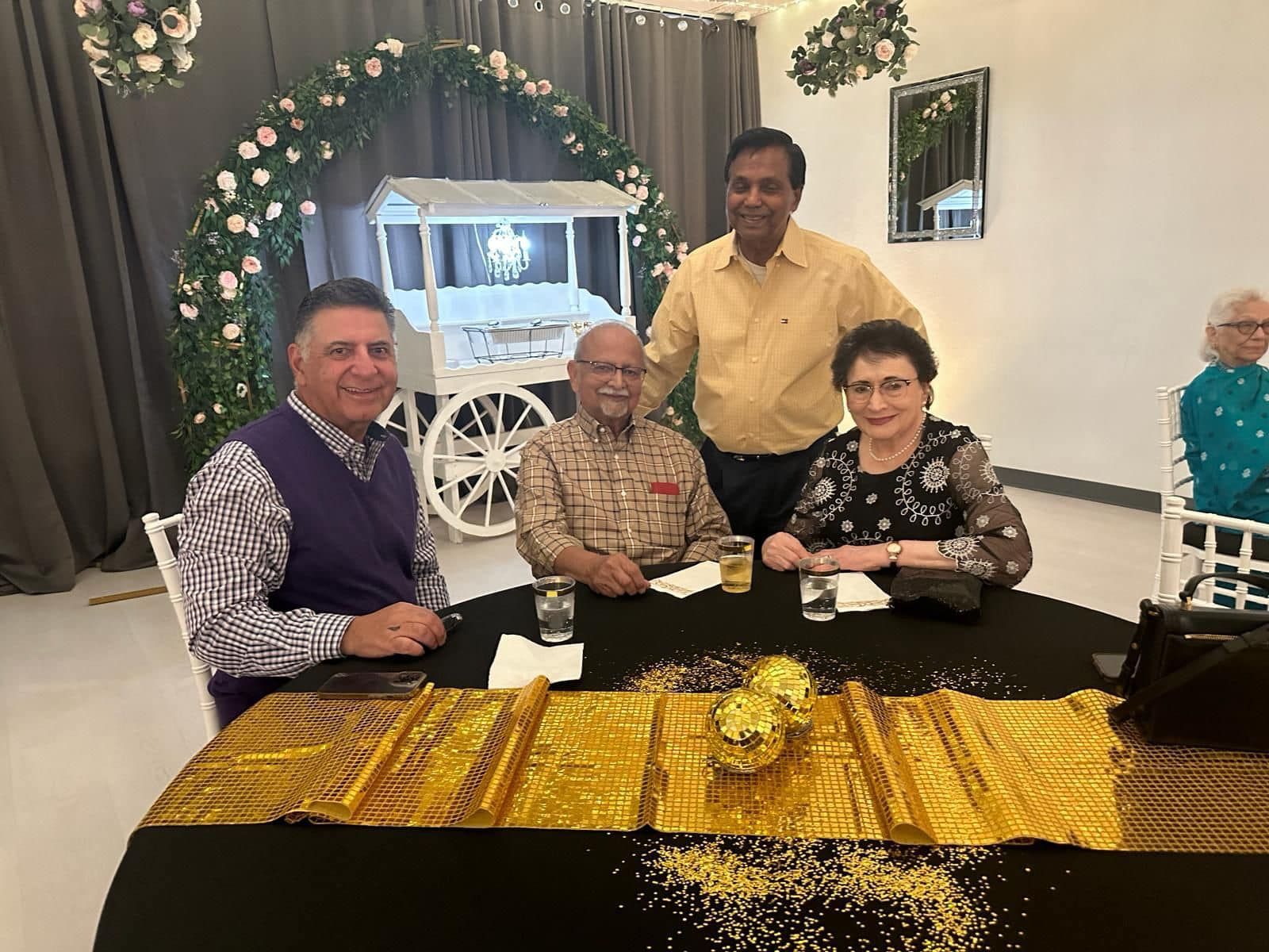 A group of people are sitting at a table in a room.