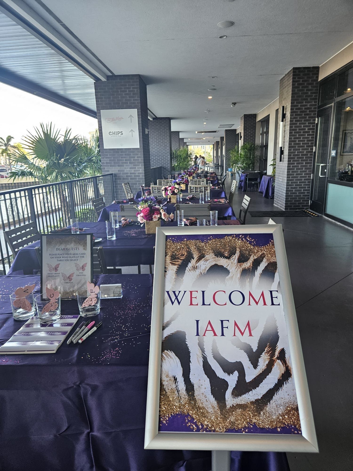 A restaurant with tables and chairs and a welcome sign