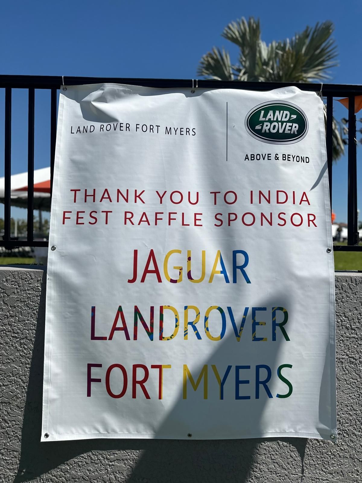 Banner thanking India Fest raffle sponsor: Jaguar Land Rover Fort Myers. White, with colorful text and logo.
