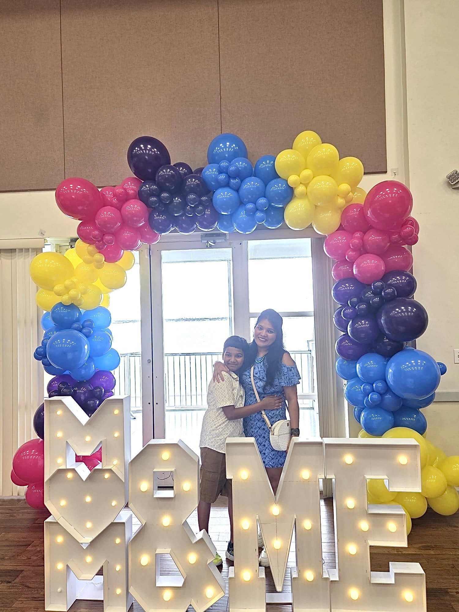 A woman and child pose by a 