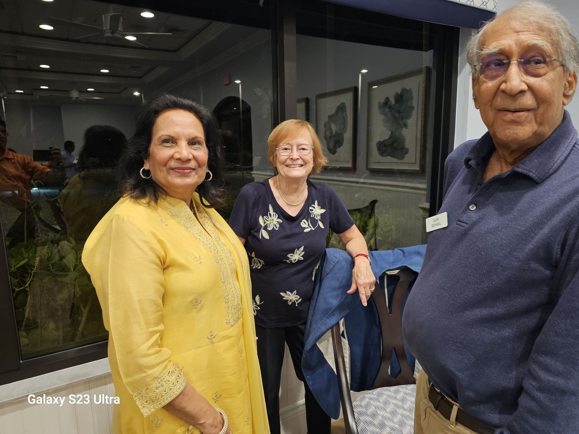 A man and two women are posing for a picture.