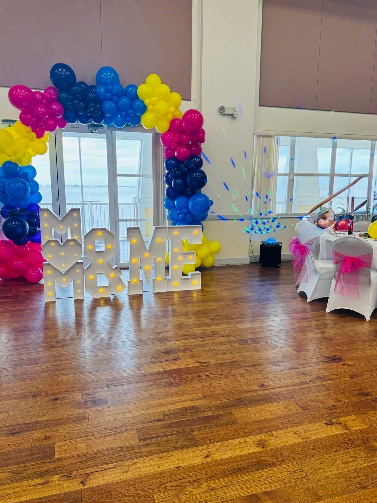 Event space decorated with balloons and lighted 