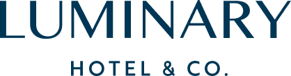 The luminary hotel and co. logo is blue and white on a white background.