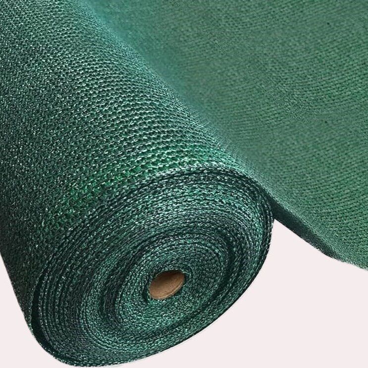 Rolled green mesh shade cloth with a central cardboard tube core