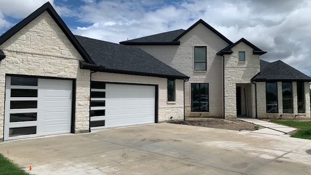 A garage under construction with a white garage door.