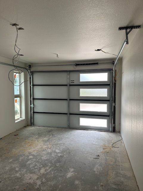 An empty garage with a garage door that is open
