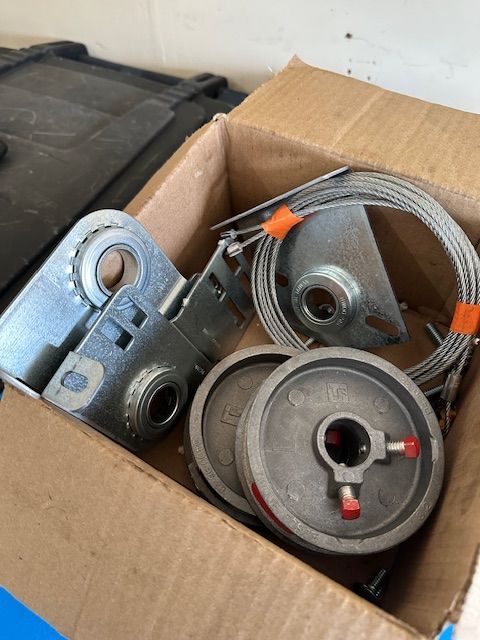 A cardboard box filled with a bunch of metal parts