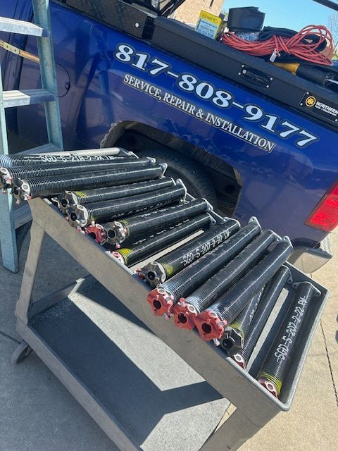 A blue truck with the number 817-808-9177 on the back