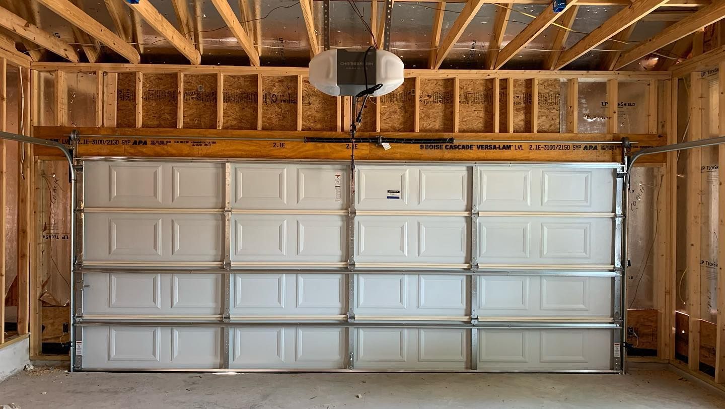 A garage door is open in a house under construction.