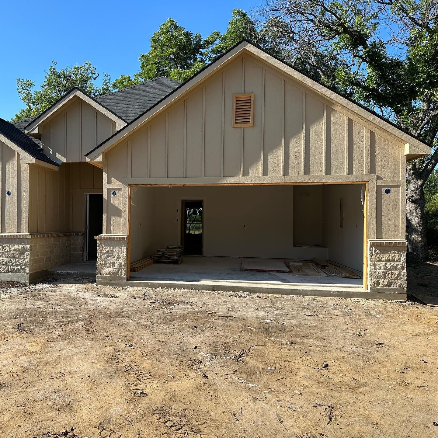 A house that is being built with a large garage
