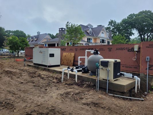 Pool equipment installation near a house with brown siding, visible plumbing, and a heat pump.