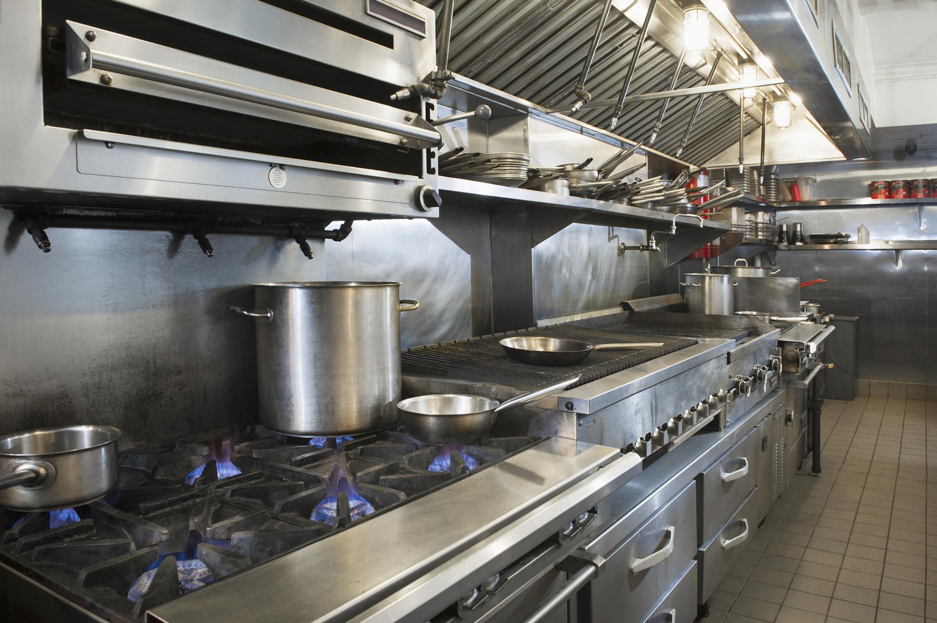 A kitchen with a lot of pots and pans on the stove